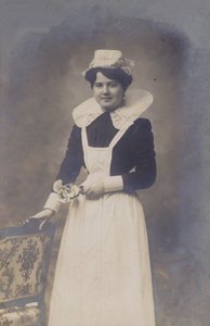 Young Girl, Maid (?), Holding a Small Bunch of Flowers by French Photographer