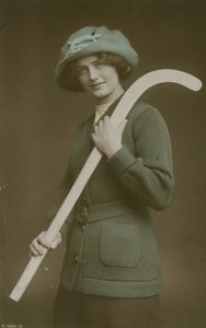 Young woman carrying a hockey stick over her shoulder by French Photographer