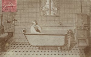 A woman in the bath in a bathroom