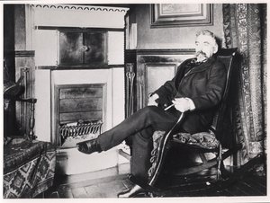 Stephane Mallarme (1842-98) seated by the fireplace at his home on Rue de Rome, Paris by French School