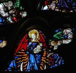 The west rose window depicting a scene from the Book of Revelation: Woman clothed as the sun, the moon under her feet and twelve stars in her nimbus