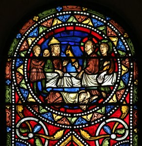 Window depicting the Charity of St Nicholas. He pays for a sick man