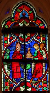 Window depicting a scene from a legend of St Nicholas: a devil gives travellers a liquid