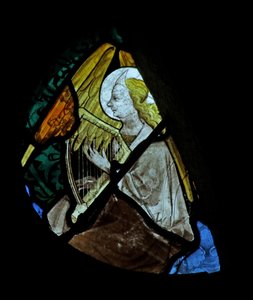Window depicting a musician angel with a harp by French School