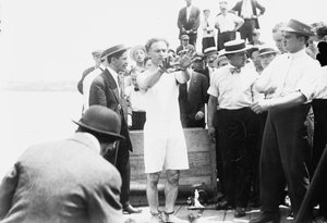 Harry Houdini being handcuffed before being nailed into a crate and lowered into New York Bay, 1912