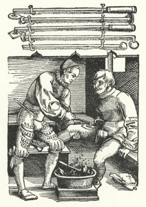 A surgeon cauterising a soldier