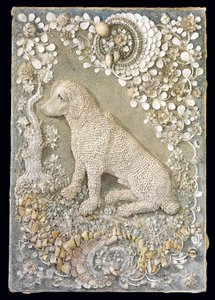 One of a pair of Louis XV seated dogs modelled in relief, within a grotto-like surround by German School