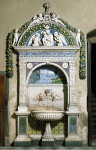 Decorated fountain with a high relief in marble and terracotta by Giovanni della Robbia. Sacristy of Santa Maria Novella, Florence by Giovanni della Robbia