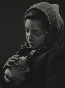 Girl holding a white kitten in her arms