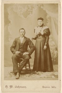 Unidentified couple: man with moustache seated, woman standing