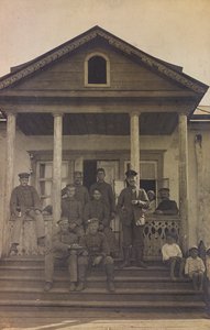First World War: Ukraine in the years 1914-1916 during the invasion of the German army. Group of soldiers on the front steps of a house (b/w photo)