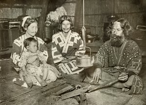 Ainu Man and Women at Home by Herbert Ponting