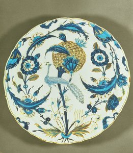 Iznik dish painted with a peacock perched among flowers, Turkey, c.1550-55 by Islamic School