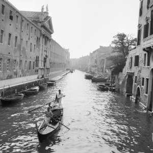 Gondoliers on a canal in Venice