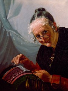 Portrait of an old woman smiling with a pair of lorgnons in front of her work