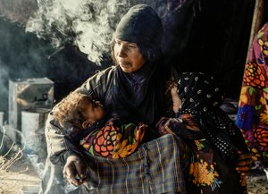 Syrian Bedouin Woman with Her Small Children in a Tent