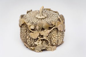 Okimono carved as four playful rats jumping over a pumpkin by Japanese School