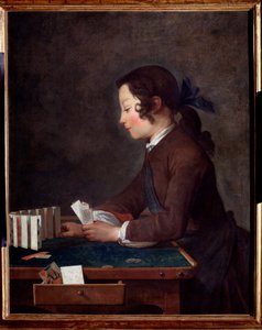 A young boy playing cards