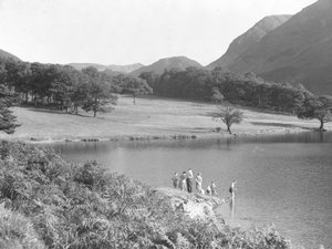 A family on the edge of the lake fishing and looking in the water by Joseph Hardman