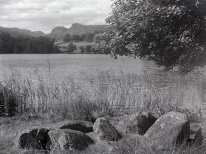 View across Loughrigg Tarn with stones in the foreground by Joseph Hardman