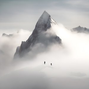 Two People Skiing Over a Cloudy Mountain 3 by Kurt Heppke