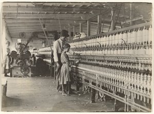 Man with Girl at Spinning Machine, South Carolina Cotton Mill by Lewis W. Hine