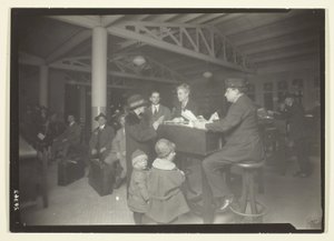 German Family, Interpreter and Recorder at Ellis Island by Lewis Wickes Hine
