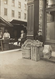 Lena Lochiavo - 11 years old, basket and pretzel seller, at Sixth Street Market in front of saloon by Lewis Wickes Hine