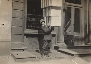 Wagon boy or "tail boy" helping to load the wagon by Lewis Wickes Hine