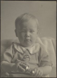 Baby Holding a Silver Rattle