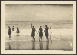 Figures on a Beach Holding Seaweed