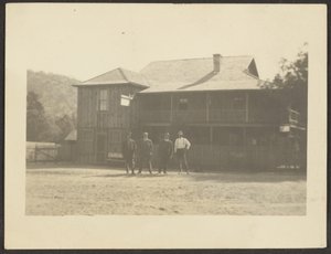 Four Men before Wooden Building by Louis Fleckenstein