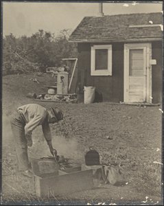 Man Bent Over Smokey Fire Outside by Louis Fleckenstein