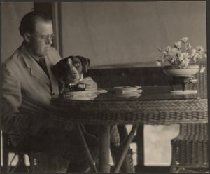 Man and Dog Seated at Table