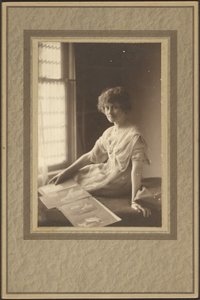 Portrait of a Woman Looking at Album