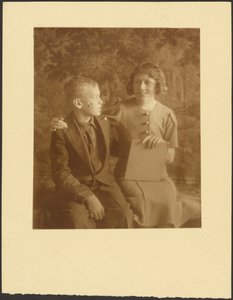 Woman and Young Man Seated Before Tapestry