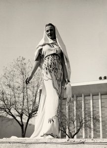 Model in an evening dress of floral print fabric, created by the couture house 