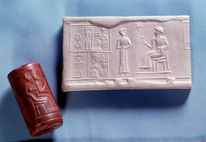 Mesopotamia: Quarz stone seal and molding representing a figure speaking to a deity