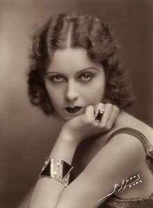 Close-up of a young woman resting her chin on her hand