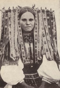 Czech woman wearing a headdress of ribbons where each ribbon denotes a suitor she refused in marriage by Photographer Czech