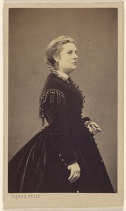 Unidentified woman wearing a dark dress, standing, in profile