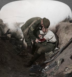 Soldier receiving first aid from a sergeant in a sap, Battle of Peronne, World War I