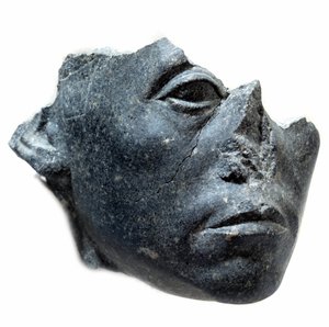 Ancient Egyptian Art: Head of King Sesostris III. Statue fragment. Black granite sculpture, circa 1900 BC by School Egyptian