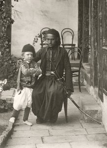 Arab kawass (Ottoman guard) with a young boy in the garden of a house in the Judea District of Jerusalem by Sergeant Henry Phillips