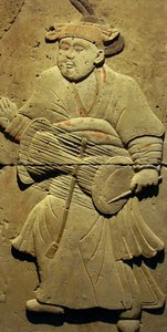 Terracotta stele with musician, Tang Dynasty (618-907), discovered in Shaanxi Province, Steles Forest Museum in Xian. Photography, Leonard de Selva, China, 2006. by Tang Dynasty Chinese School