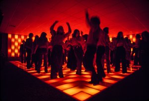 Young dancers at a nightclub dancing on an illuminated floor by Ted Spiegel
