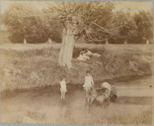 Three Children and a Dog Playing in the Creek