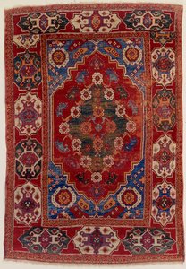 A Transylvanian Rug with Floral Motifs on a Brick Red Background