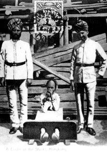 A coolie in the stocks, Hong Kong by Unbekannt