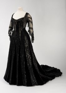 Black full length evening gown worn by Queen Alexandra, with bead and sequin decoration and incorporating Queen Alexandra’s signature black silk and gold lettered name tape, made by Barolet of Knightsbridge, London 1908-1910